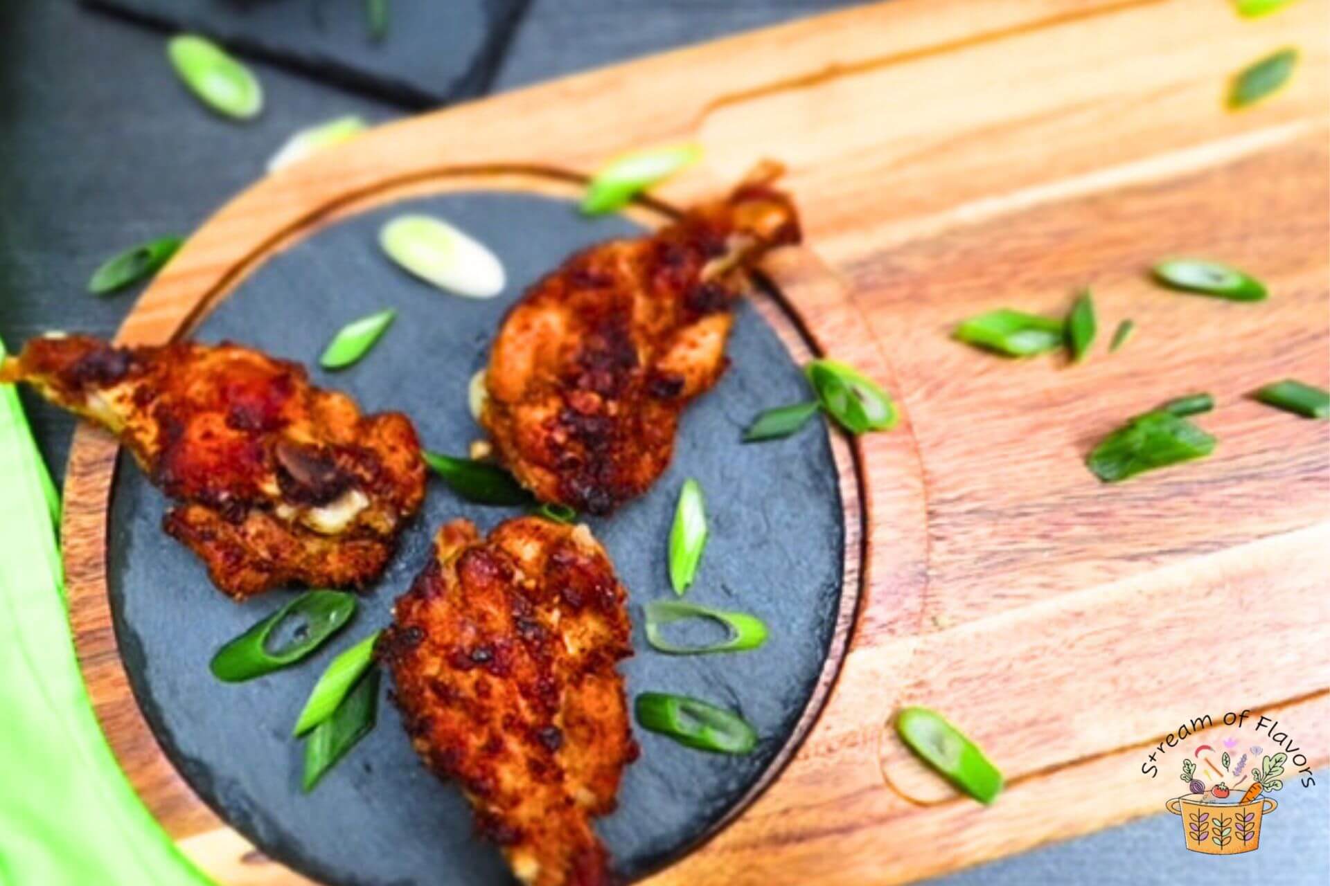 five spice chicken wings on stone and wooden board