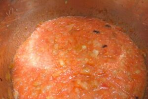 onion and tomato puree in a pot