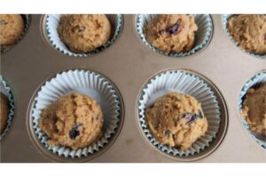 diabetic blueberry muffin recipe spooned into muffin tin lined with baking cups