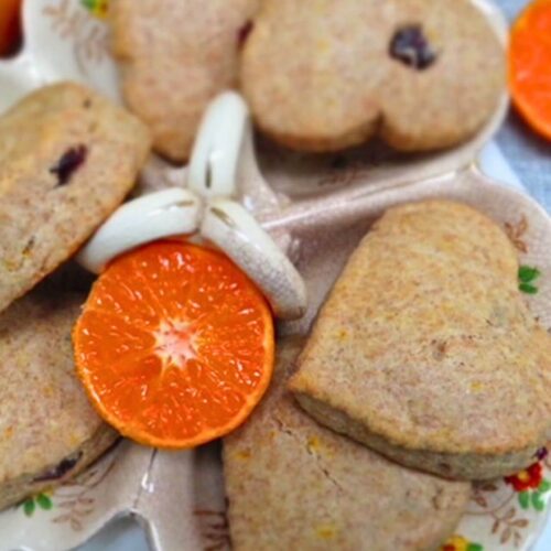 easy orange scones recipe in a bowl with a cut orange