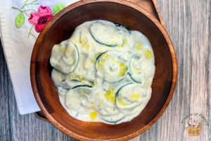 healthy tzatziki in a wooden bowl with olive oil