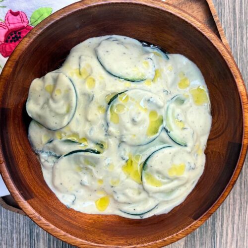 healthy tzatziki in a wooden bowl with olive oil