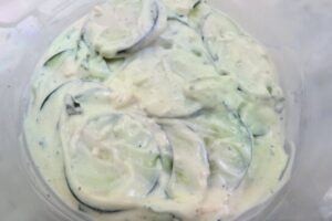 sliced cucumbers in the tzatziki sauce