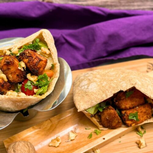 fish shawarma on a wooden board with cilantro