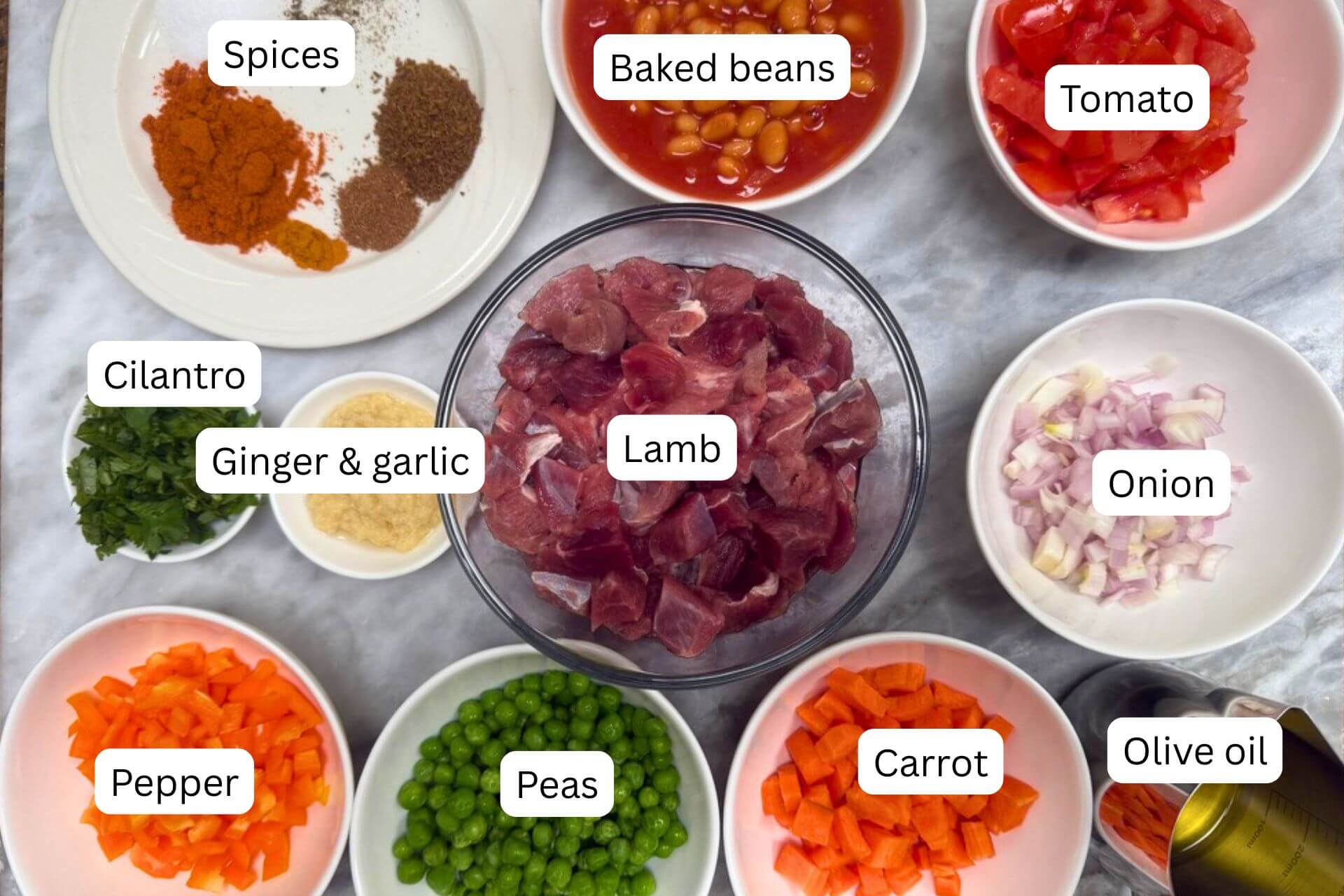 measured ingredients in bowls for the lamb stew