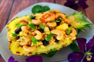 pineapple fried rice recipe in a pineapple shell with cashews