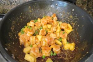 shrimp, veggies and pineapple in a wok