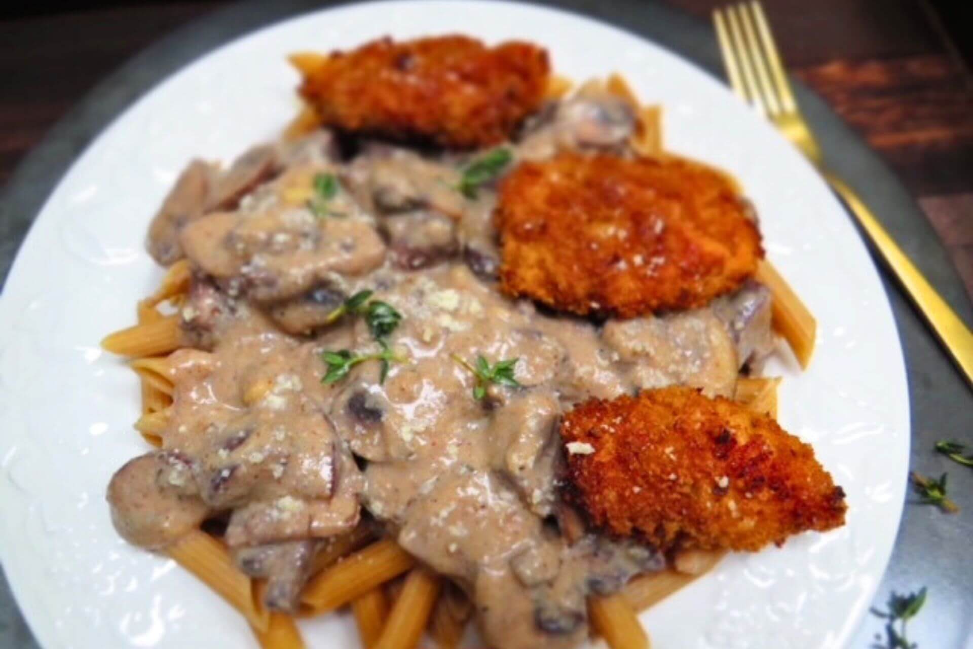 healthy cajun chicken pasta in a white plate