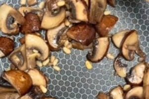 mushrooms and pine nuts in a pan