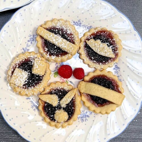 raspberry jam tarts on a white plate