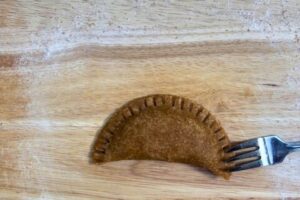 edges of the dough sealed using tines of a fork