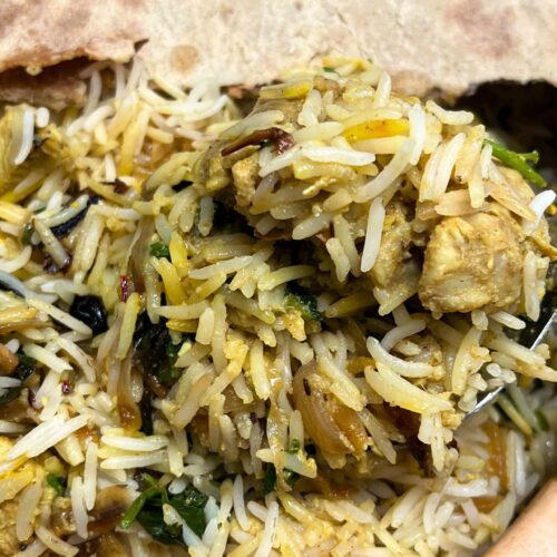 chicken dum biryani recipe in a clay pot covered partially with wheat bread