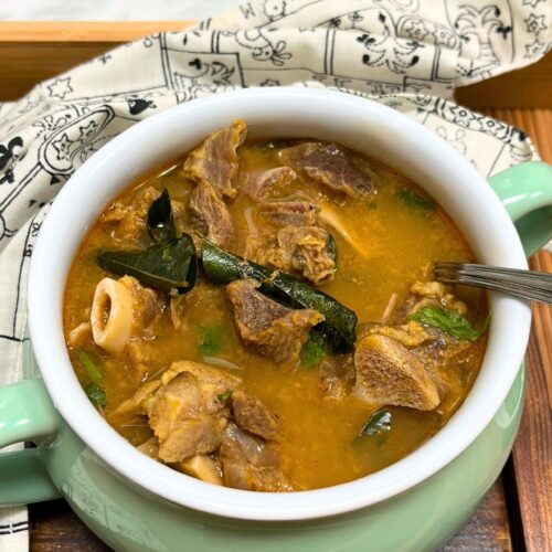 mutton bone soup in a green bowl