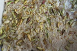 smoothen the kalakand with condensed milk and sprinkle pistachios