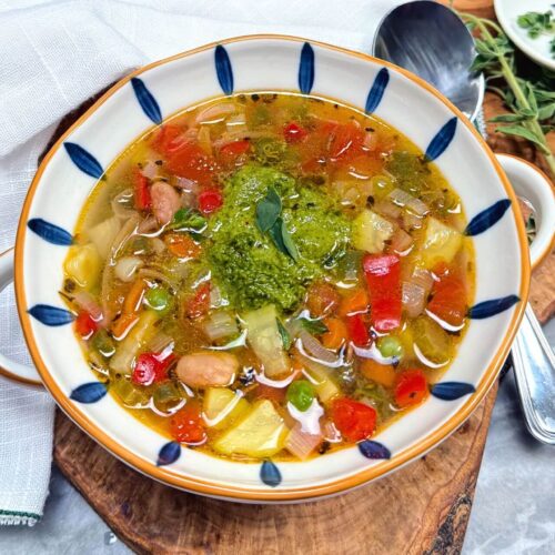 Provencal vegetable soup in a blue and white bowl with pistou