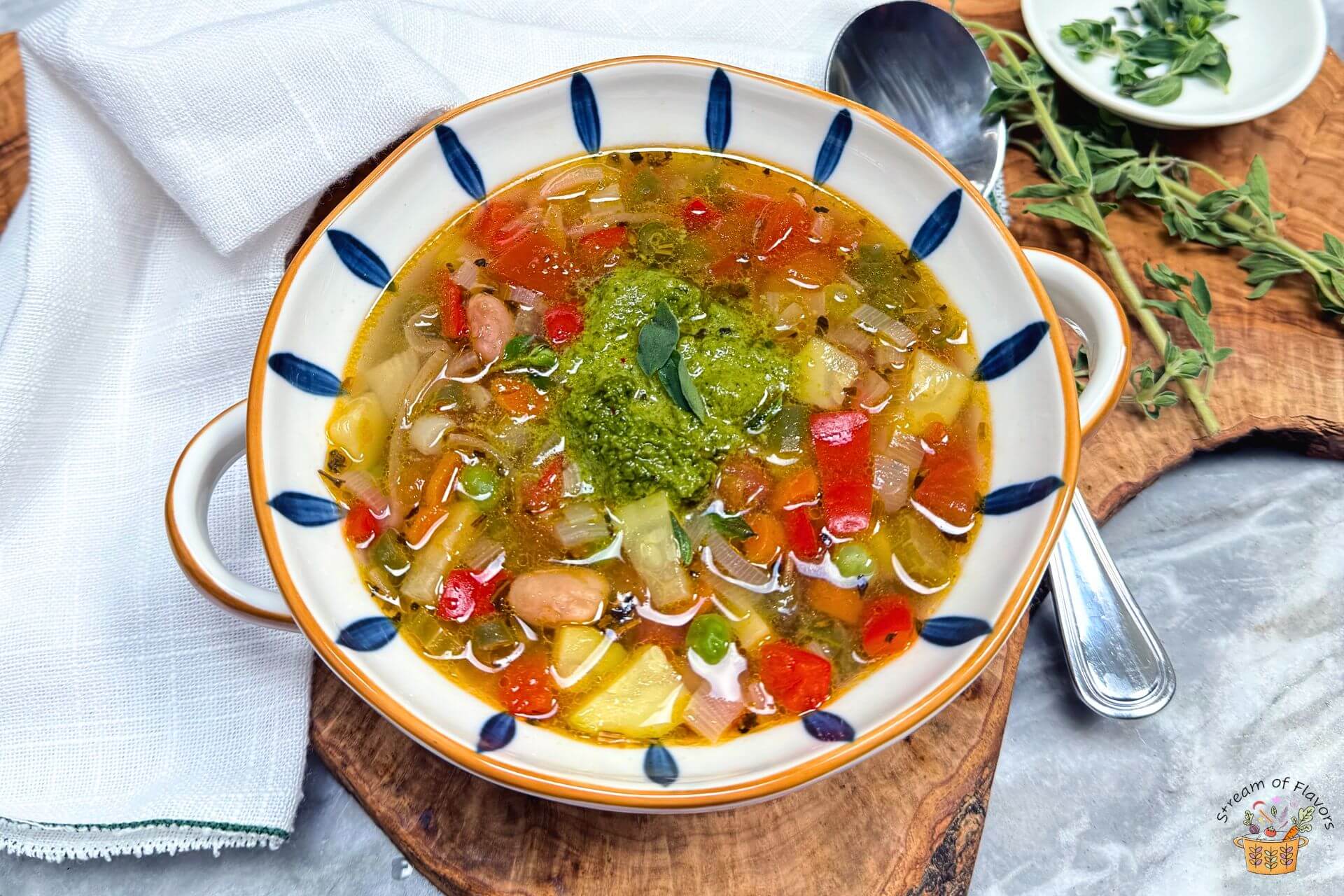 Provencal vegetable soup in a blue and white bowl with pistou