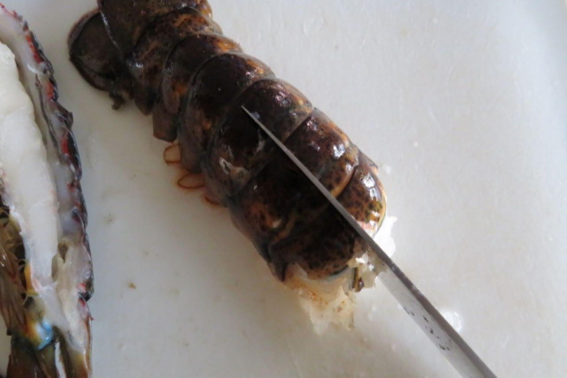 lobster tail cut in two with a knife