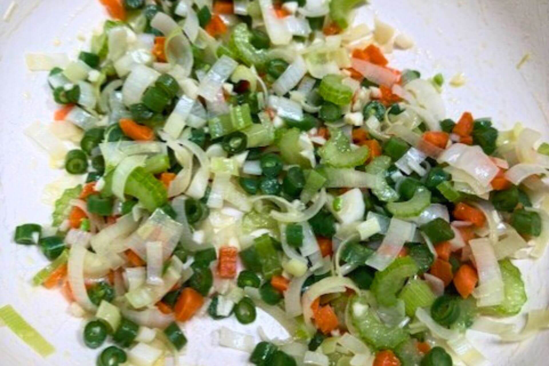 leeks, celery, and carrots and beans in the pot