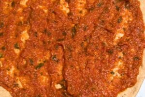 spread the sauce on the pizza base