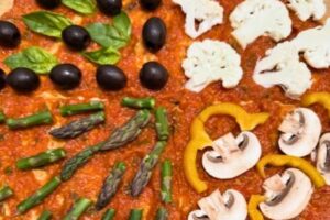 vegetables on pizza base with sauce