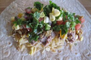 salsa and cilantro on burrito