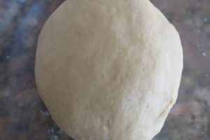 place Bath bun dough in a bowl