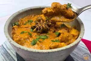 healthy butter chicken with cilantro in a gray bowl