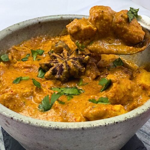 healthy butter chicken with boneless pieces shown in a spoon