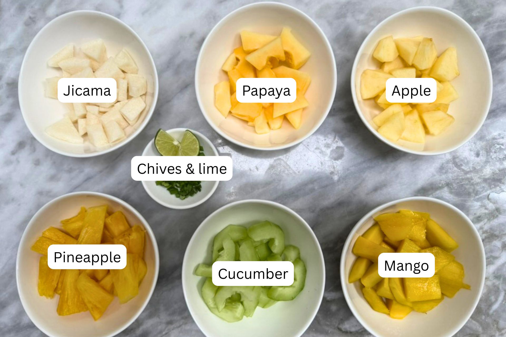 measured ingredients for the rujak salad recipe in bowls