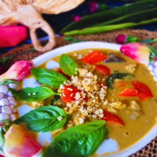 Panang chicken curry in a bowl with basil