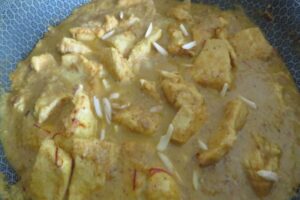 chicken pasanda in a pot with slivered almonds