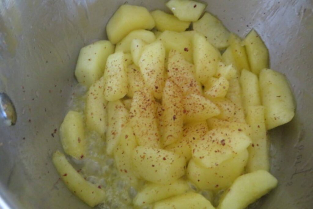 apple slices in a pot with nutmeg