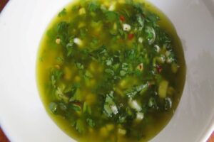 olive oil in a bowl mixed with cilantro