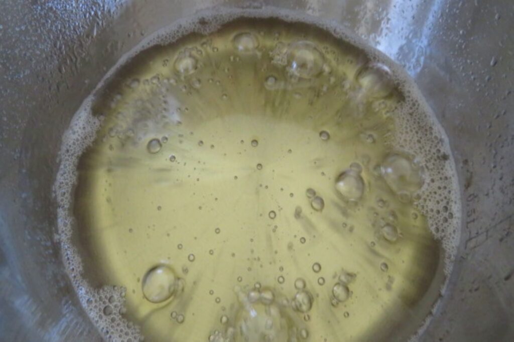the sugar syrup boiling in a pot