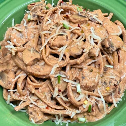 linguine with mushrooms recipe with grated Parmesan cheese in a green pasta bowl