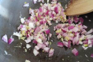 onions with aromatics in a pan