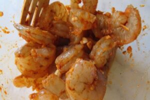 add the spices and salt and mix into the shrimp