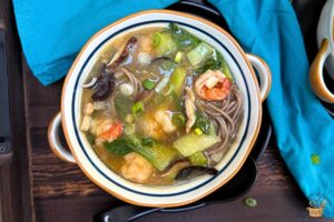 long soup with shrimp, bok choy and mushrooms in a bowl