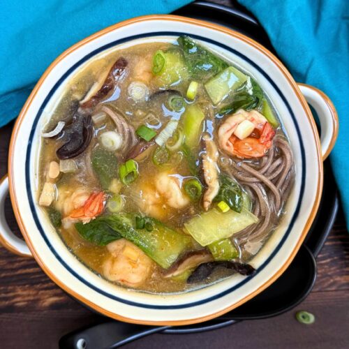 long soup with shrimp, bok choy and mushrooms in a bowl