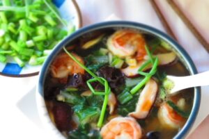 long soup recipe in a bowl with green onions