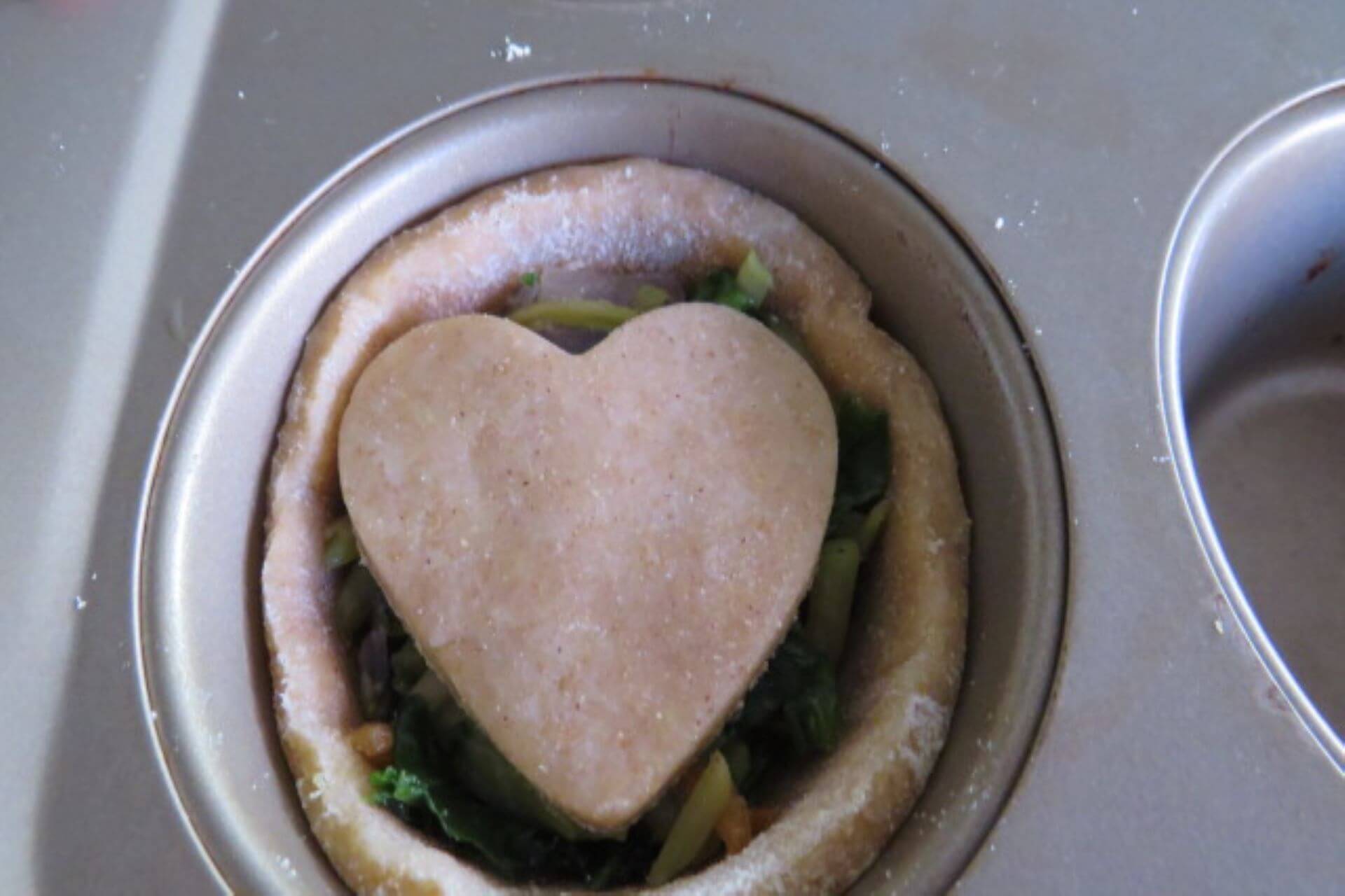 spinach pastries recipe with a small heart cut out of pastry on top
