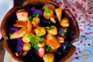 chana salad recipe served in a wooden bowl