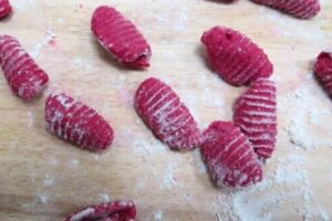 beetroot gnocchi on a floured surface