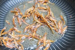 ikan bilis fried in a pan