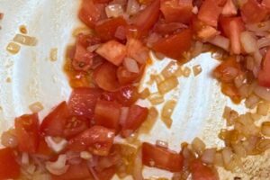 onion and tomato in a pan