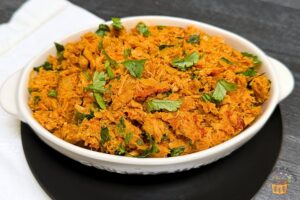 tuna fish masala with cilantro in a white bowl