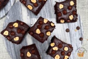 avocado brownie made with my recipe with hazelnuts on top on a gray platter