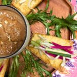 tahu goreng recipe on a wooden tray with lettuce