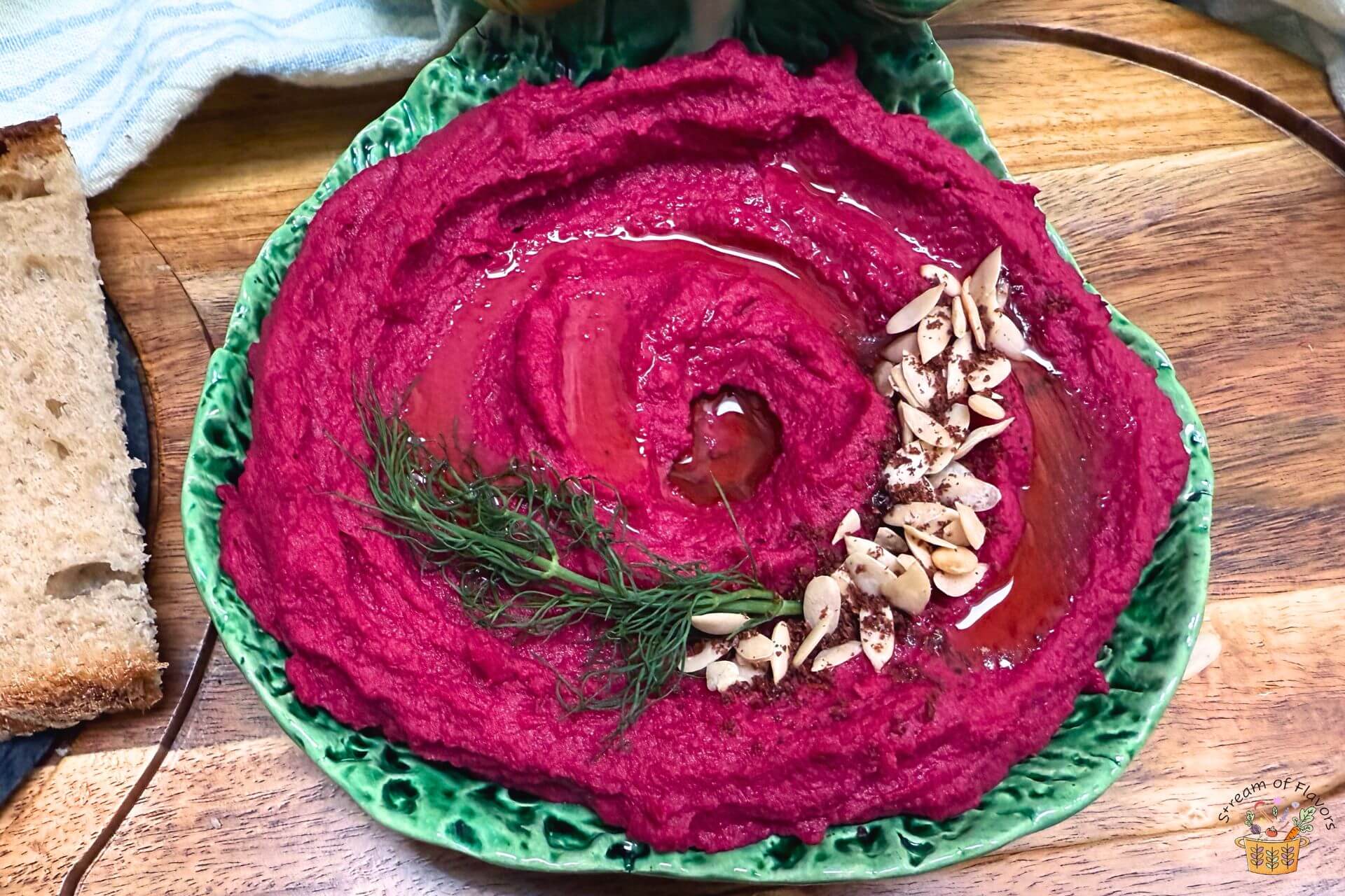 hummus with roasted beet in a green bowl