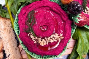 roasted beet hummus with watermelon seeds and dill